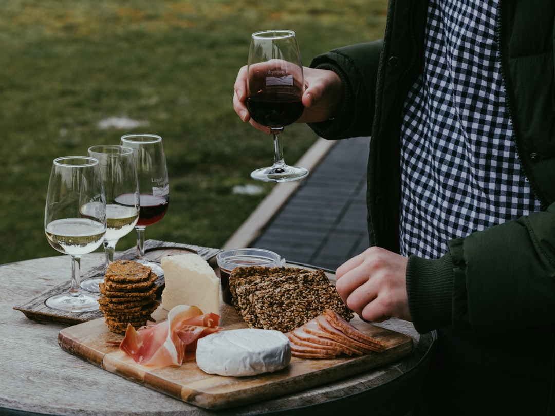 Wine tasting with cheese and crackers in a vineyard setting