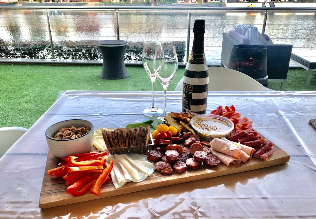 Wine bottle, glasses, and charcuterie board on an outdoor table