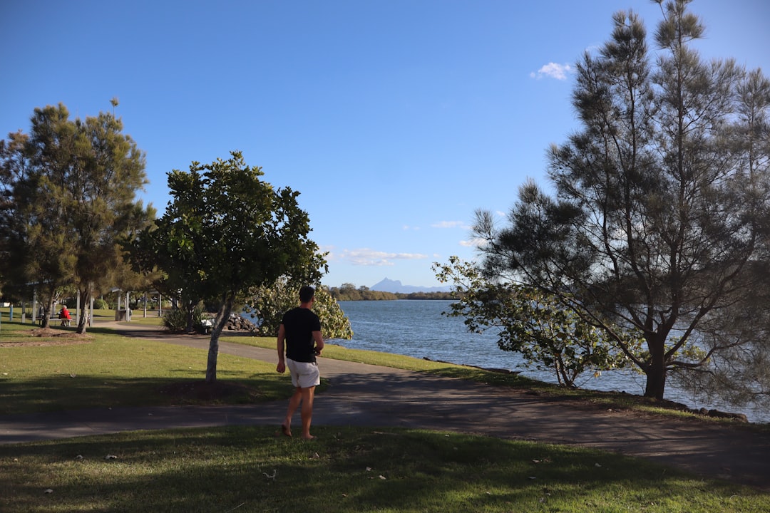 Man walking on path by the water